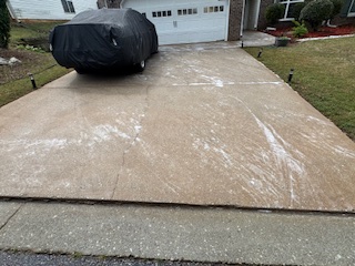 Bright, clean concrete driveway after professional surface cleaning and pressure washing in Ellenwood, GA