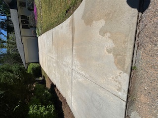 Bright concrete driveway after washing service in Rex, Georgia