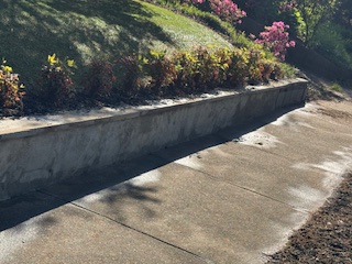 Same patio area with cleaner concrete and a brighter appearance after washing.