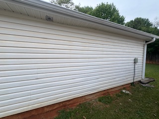 Same wall and walk looking cleaner and brighter after washing.