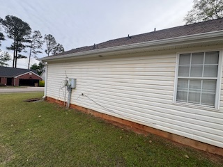 Same elevation with clean siding and a tidier appearance after soft washing.