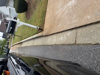 Same neighborhood curb and sidewalk scene after cleaning